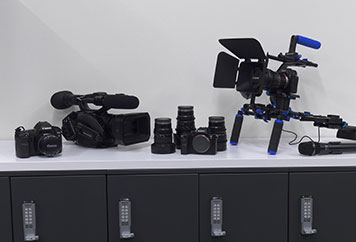 digital video and camera equipment on shelf.