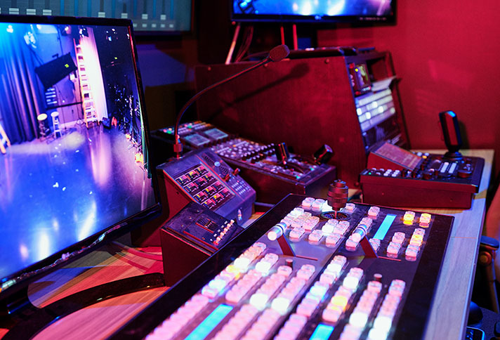close up view of control keypads, monitors and studio equipment