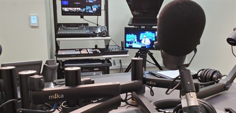 Photo of audio recording room with sound boards