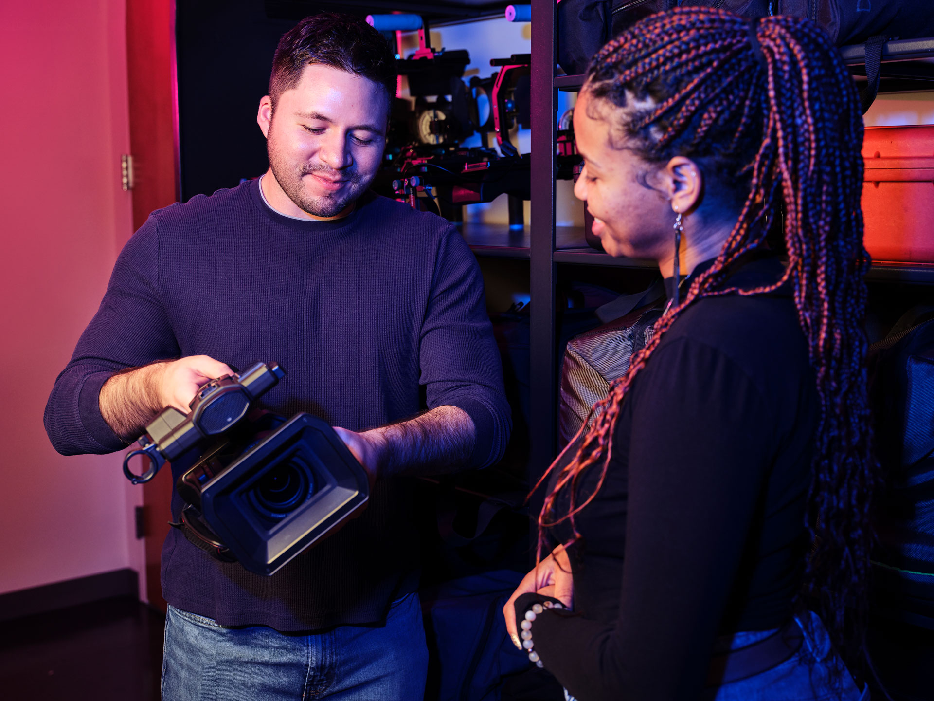 Man demonstrating use of Panasonic Camera to a woman