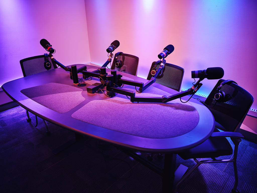 table at podcast studio with microphones