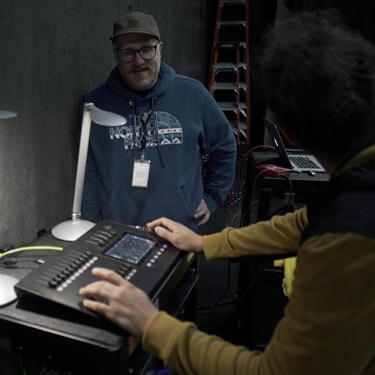 Instructor guiding student in using Colorsource AV console